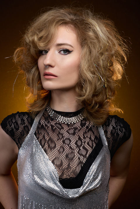 blonde model featuring retro glam hairstyle reminiscent of barbarella