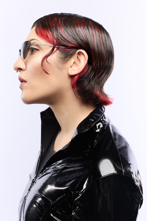 beauty photograph of a female model styled as trinity from the matrix on a white background