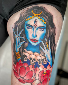 A neo traditional tattoo of Mahakali, tattooed in blues, reds and yellow inks