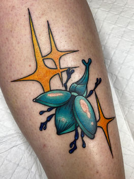 A colourful neotraditional beetle tattoo