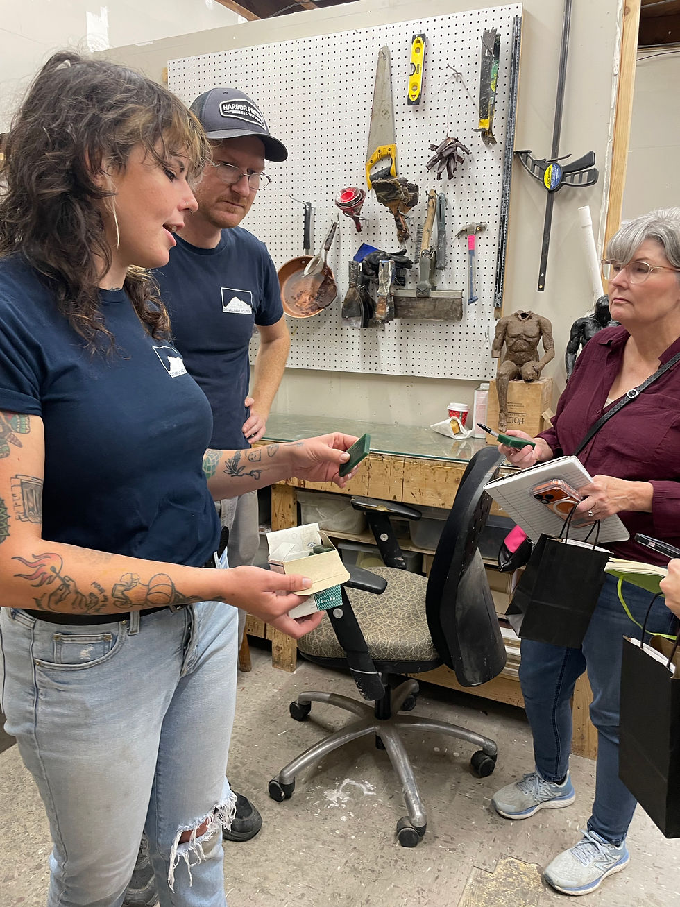 Emily Brannan and Charlie Mabry show visitors around the wax room.