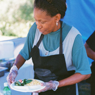 The chef at Taste of Rwanda is preparing an order for customers