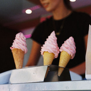Delicious looking Cream icecreams are lined up awaiting collection