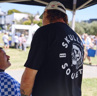 Matiu the barber at the Skullet Society is talking to a client in the park