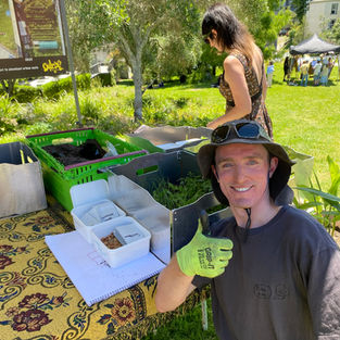 Levi from Delicious Revolution gives the thumbs up in front of his stall