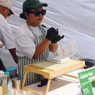Gotcha Matcha stallholder serving a customer at the February event