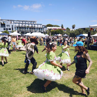 Dancers, artists and a range of event attendees shown interacting and participating in the event