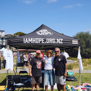 Brent from Uptown standing with Tracy and Mike King in front of the I AM Hope stall
