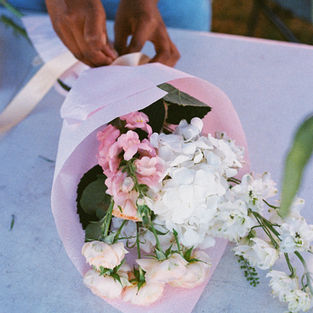 A pretty bouquet of flowers from &Flowers stall is wrapped and ready to be collected