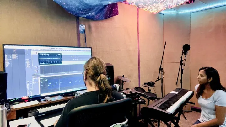 Working together at the studio keyboard and recording desk.