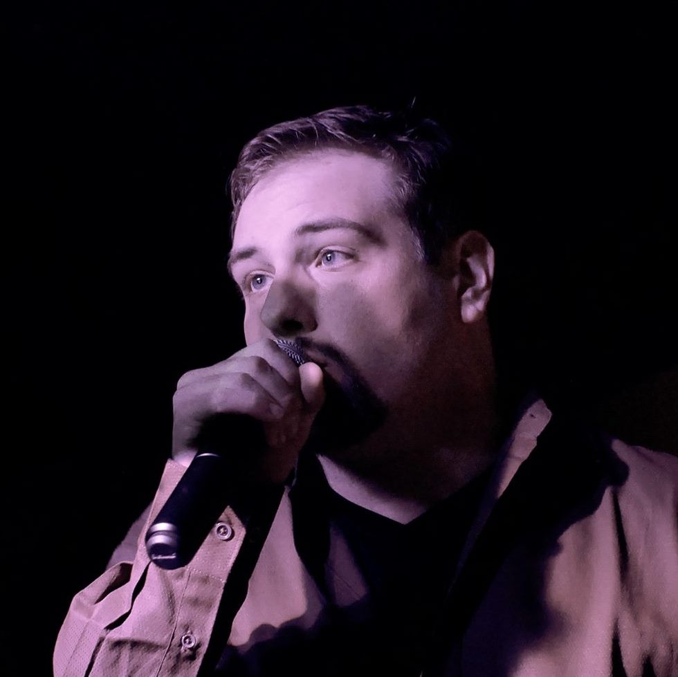 Eric Bodreau performing with a microphone