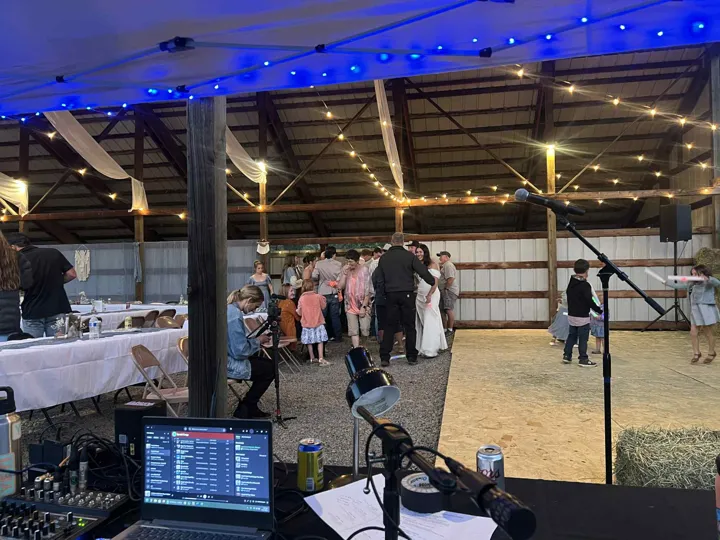 Reception sound and lighting from behind the DJ setup.