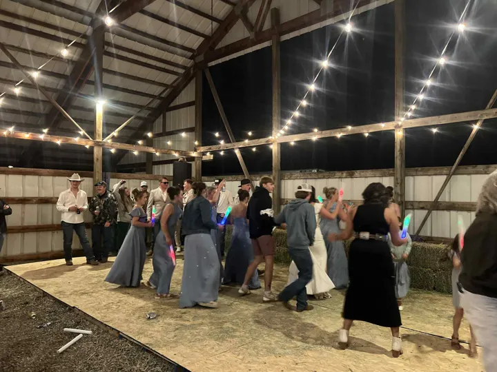 A wedding dance floor under the barn lights.