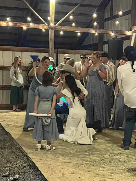 Wedding guests gathered beneath the string lights.