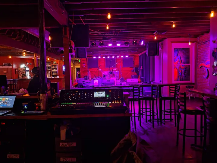 A venue stage with sound and lighting in place.