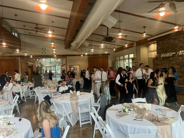 Wedding guests celebrating inside the reception hall.