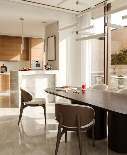 Modern dining room with table and chairs near kitchen; Nu Projects Dubai