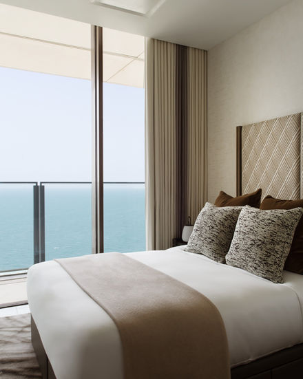 Bedroom with bed and ocean view. Luxury living, modern design, calm space.