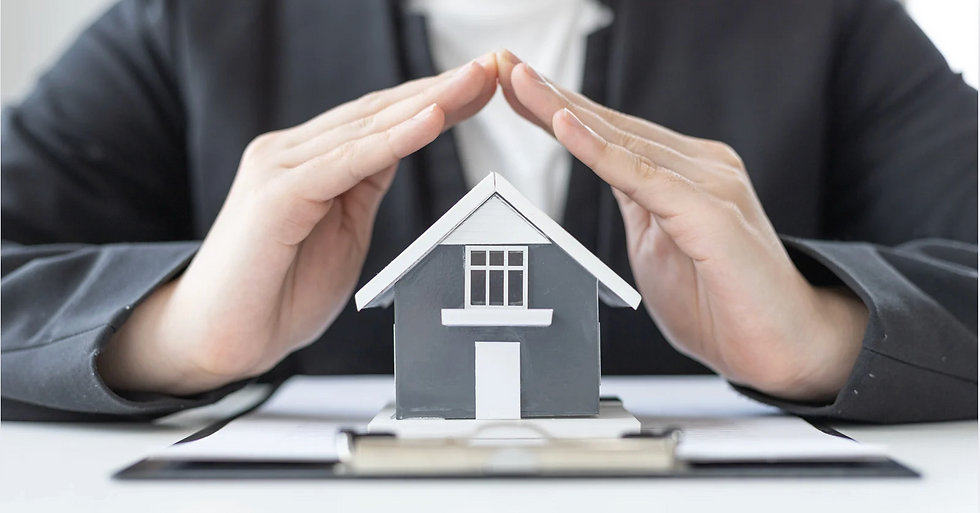 Professional cupping hands over a home model representing HOA master insurance coverage and deductible risk for condo buyers in Coastal Orange County