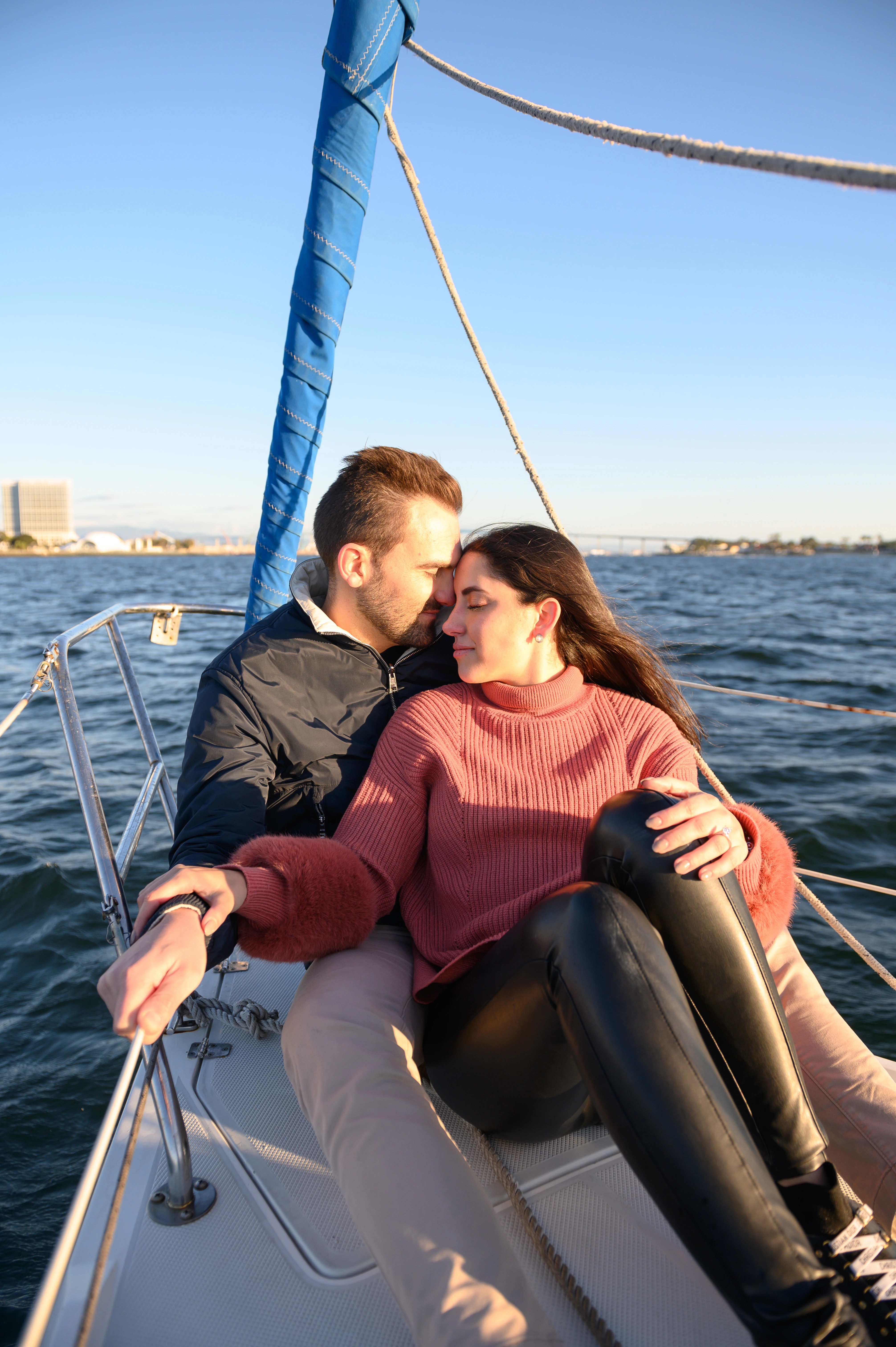 Couple enjoying a romantic sailboat proposal in San Diego, showcasing the beauty of love and the ocean. San Diego proposal photographer capturing intimate moments.