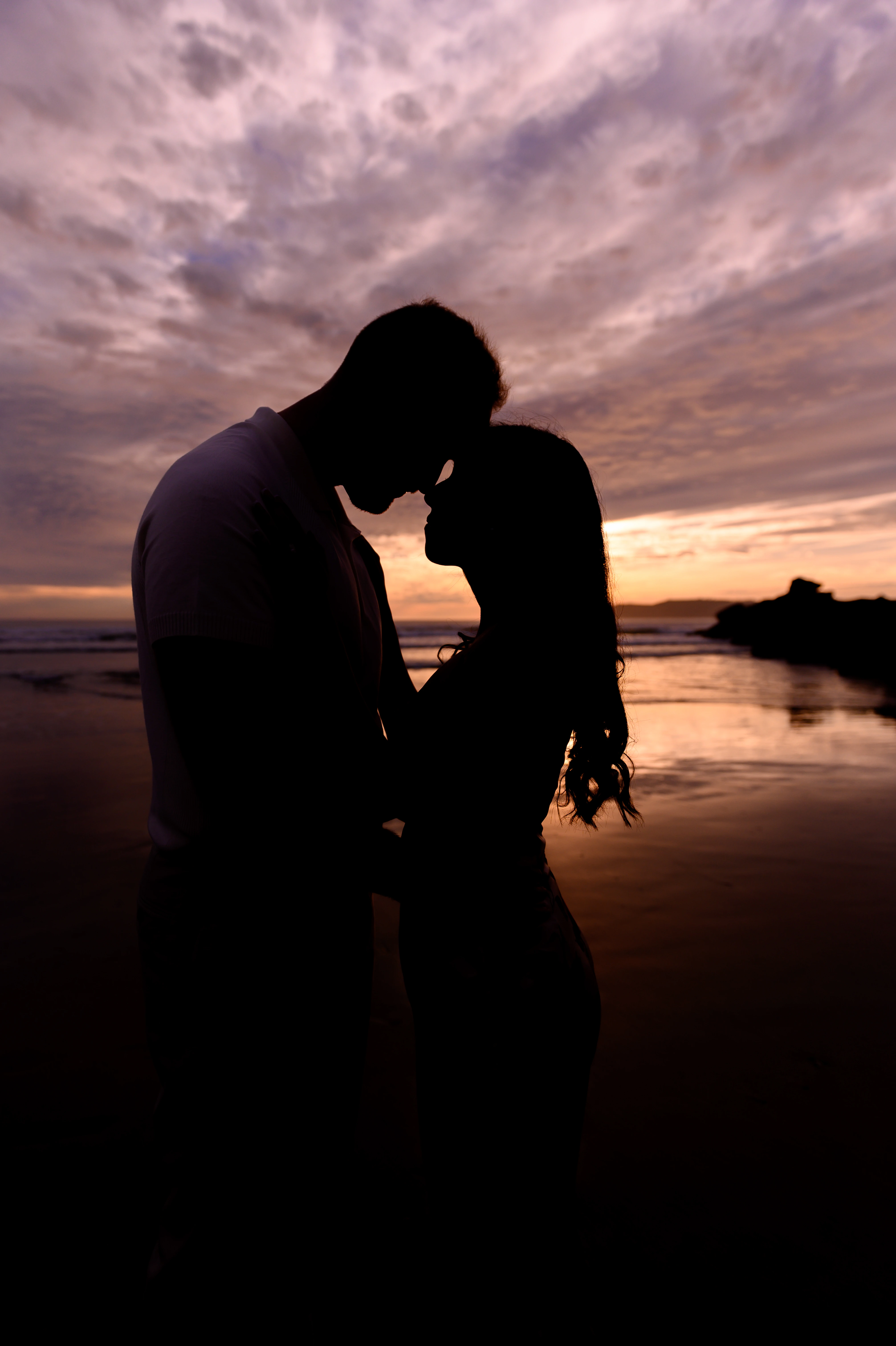 couple hugging after proposal Coronado Beach ocean