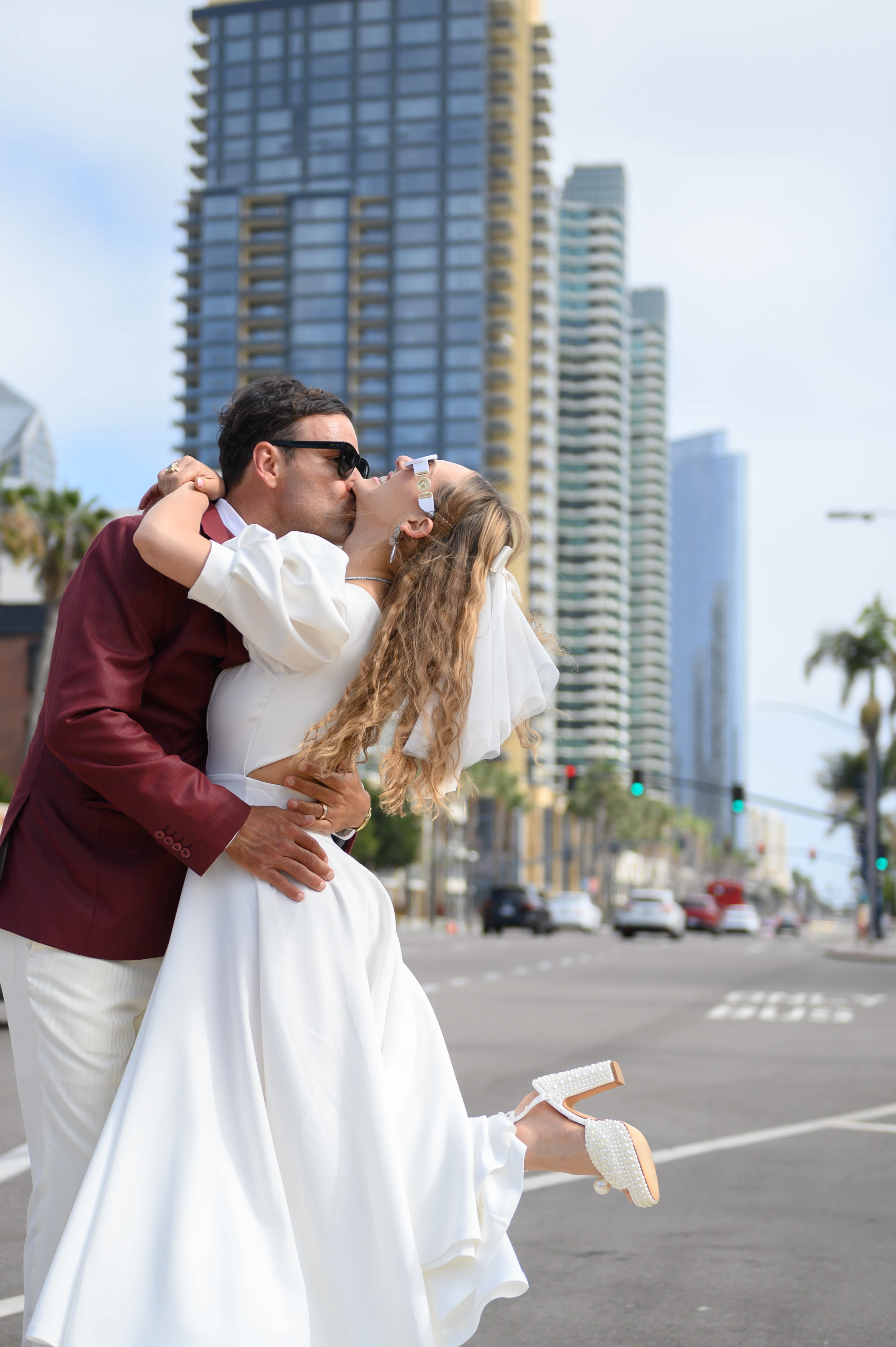 couple dancing in the heart of san diego with skyline at the background