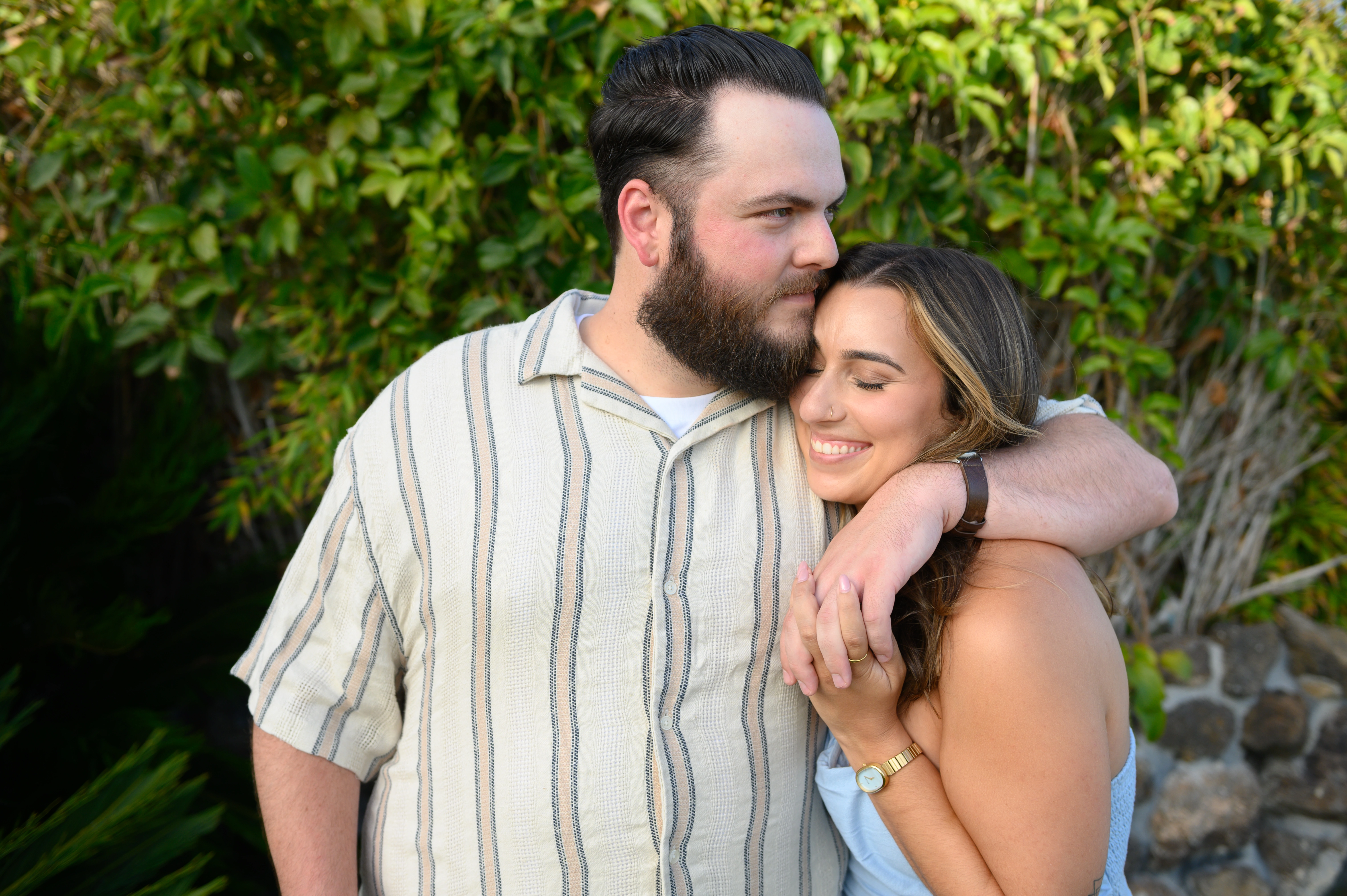 Couple holding hands near the San Diego bay, a perfect setting for engagement photography by an affordable San Diego proposal photographer.