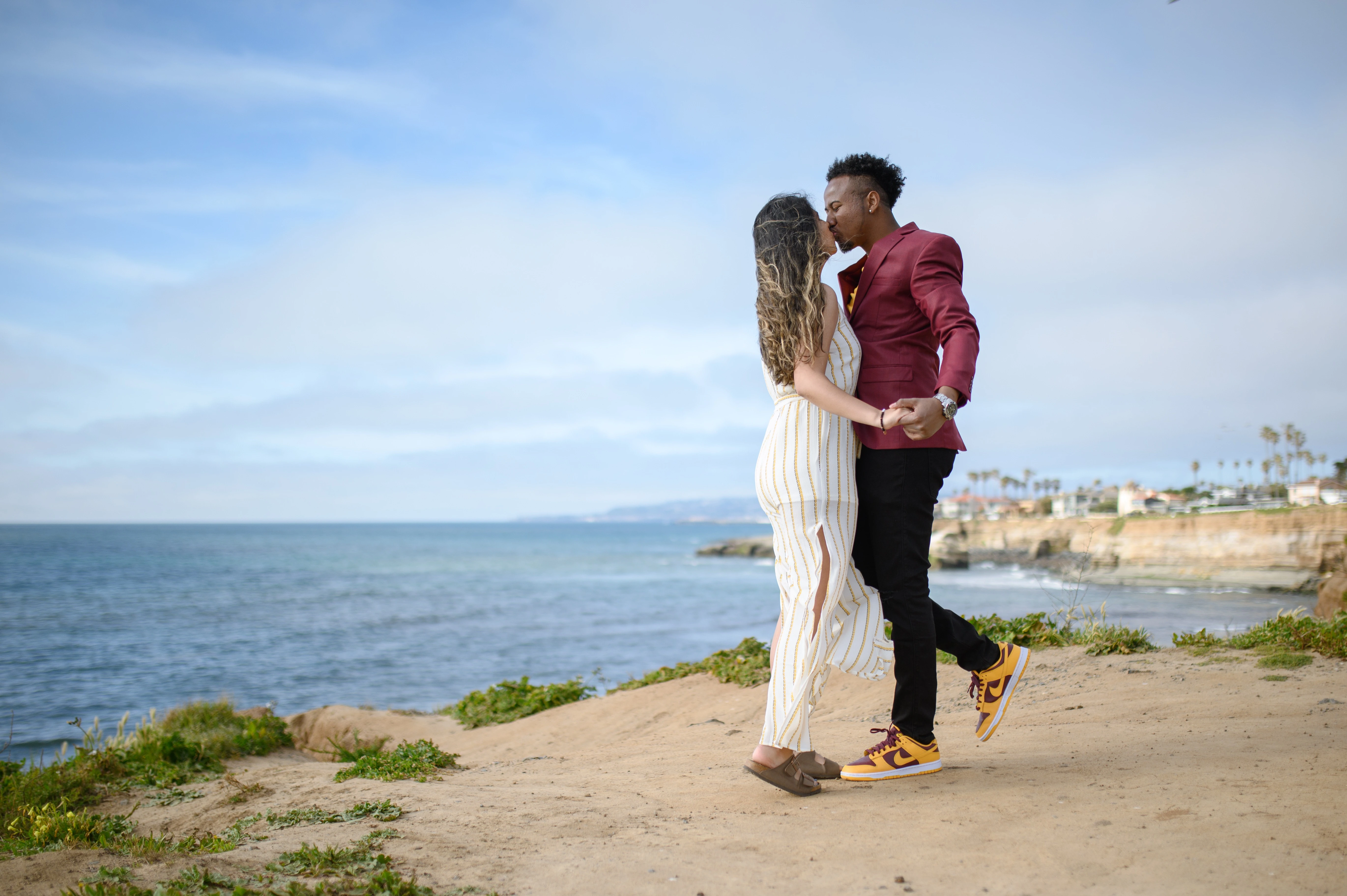 Couple embracing at Sunset Cliffs, showcasing a romantic atmosphere ideal for a San Diego proposal photographer.