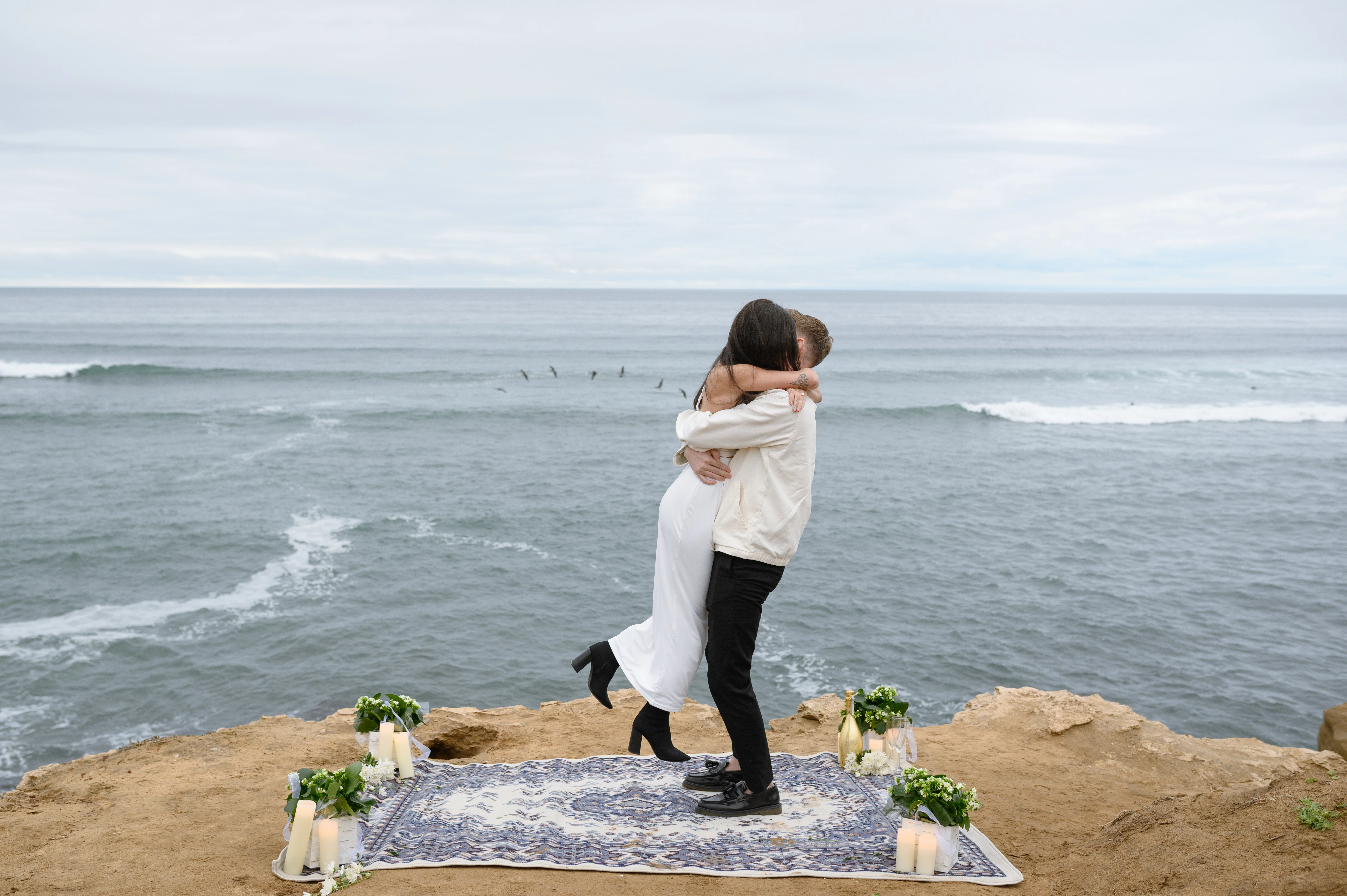 couple hugging after proposal Sunset Cliffs ocean