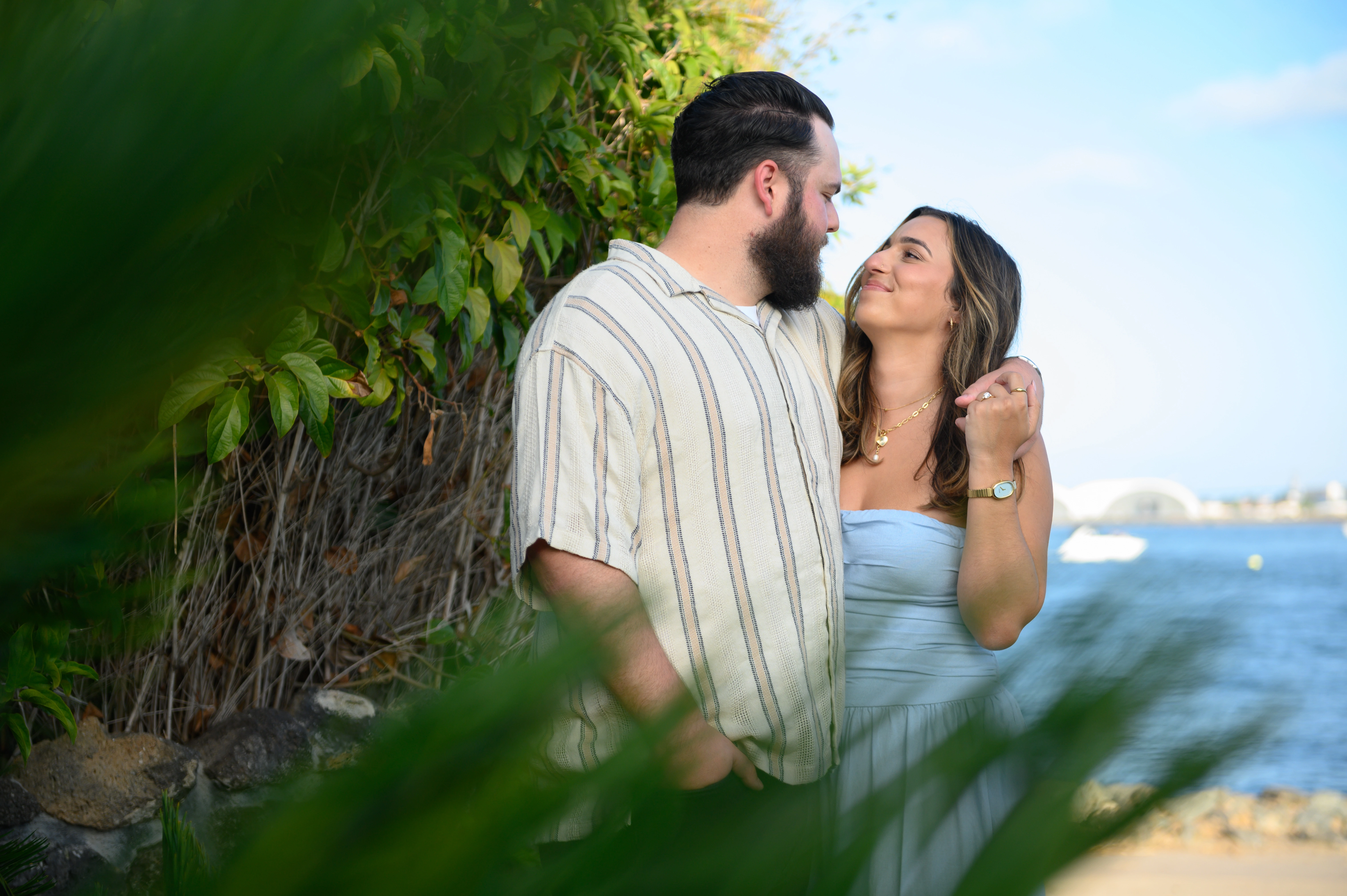 Intimate embrace of a couple in a lush garden, ideal for romantic proposal photography in San Diego.