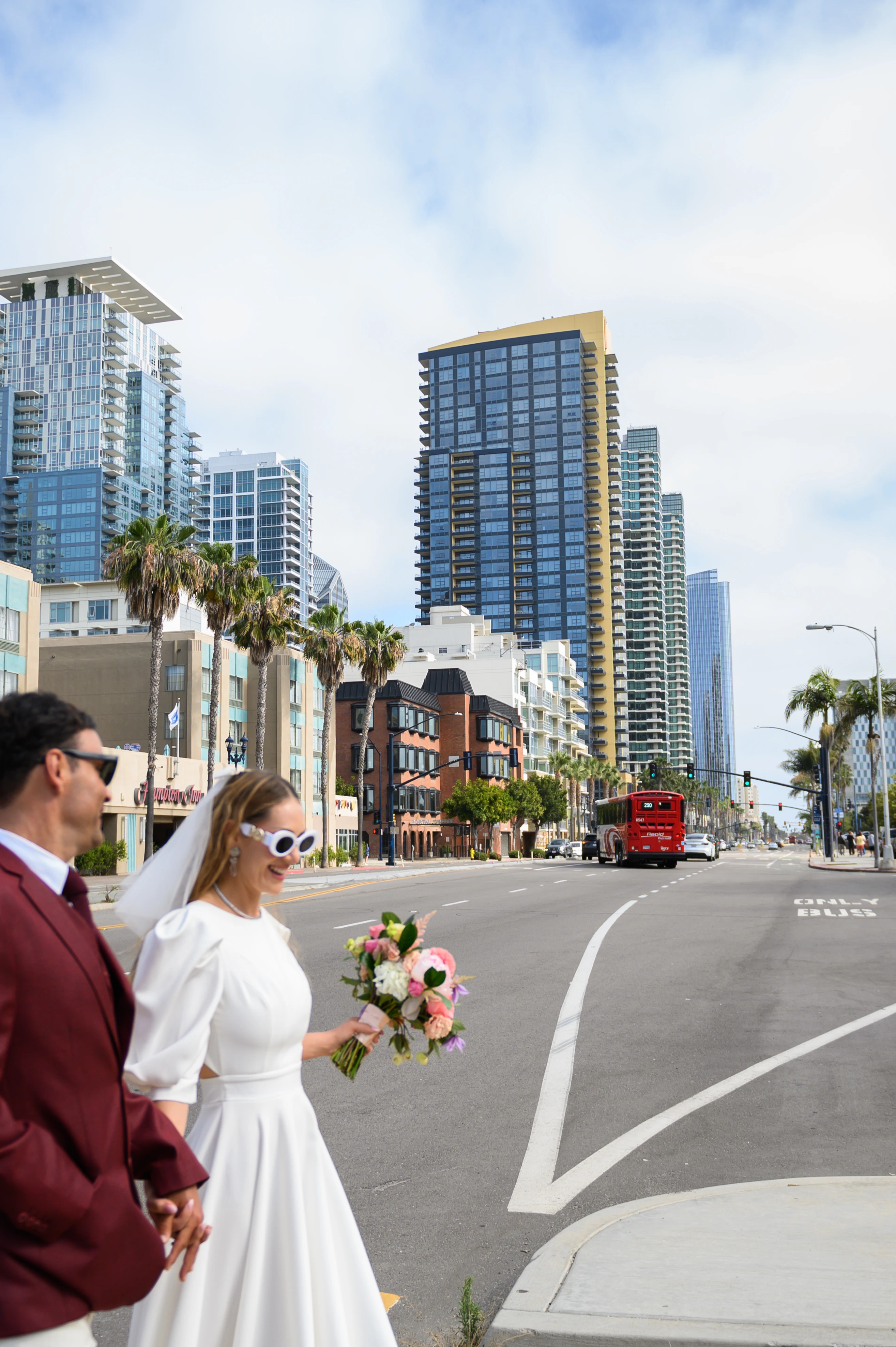 modern elopement portrait of couple at waterfront park with urban skyline backdrop