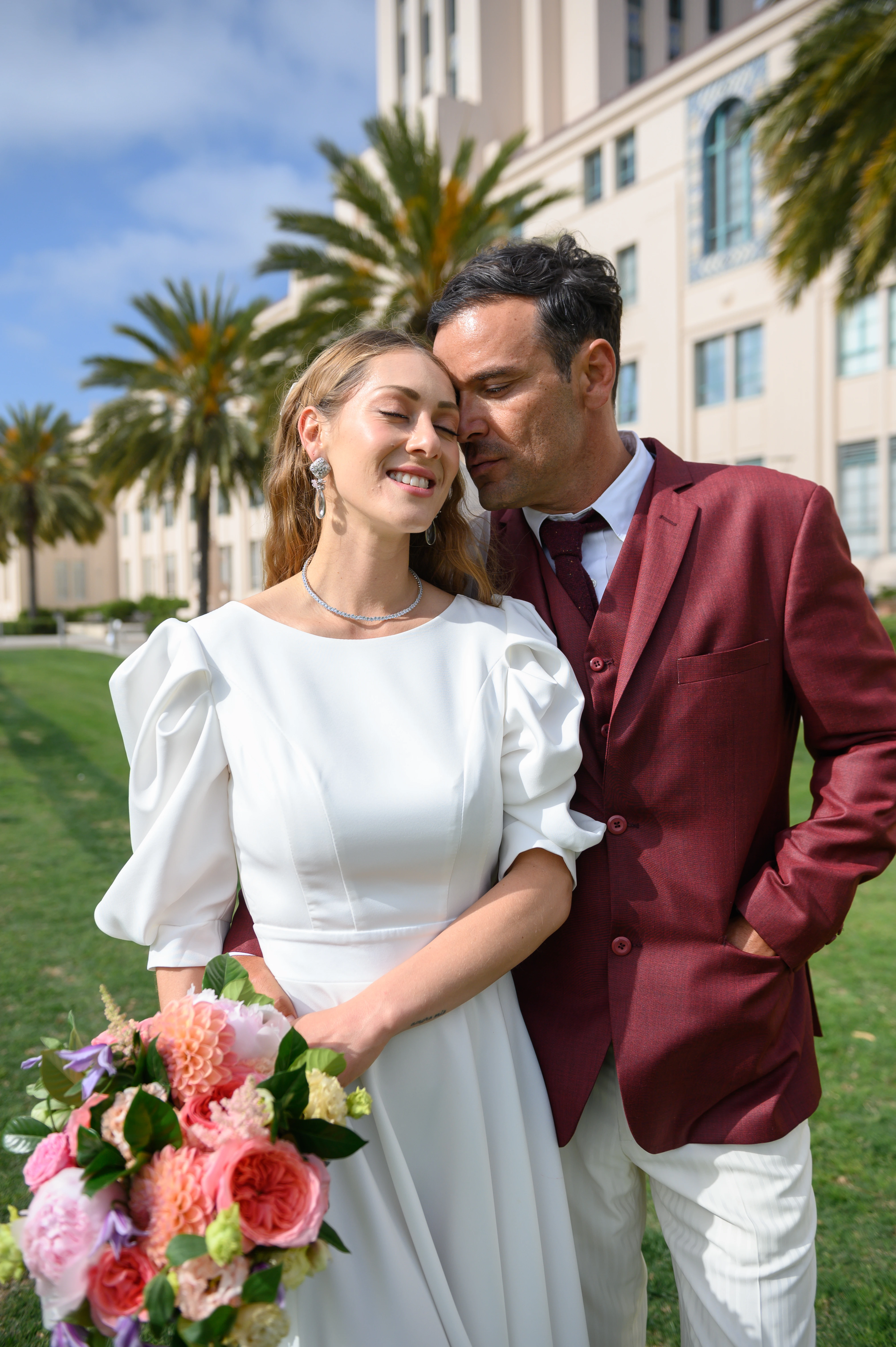 Tender elopement moment with groom nuzzling bride's cheek, eyes closed, at san diego waterfront 