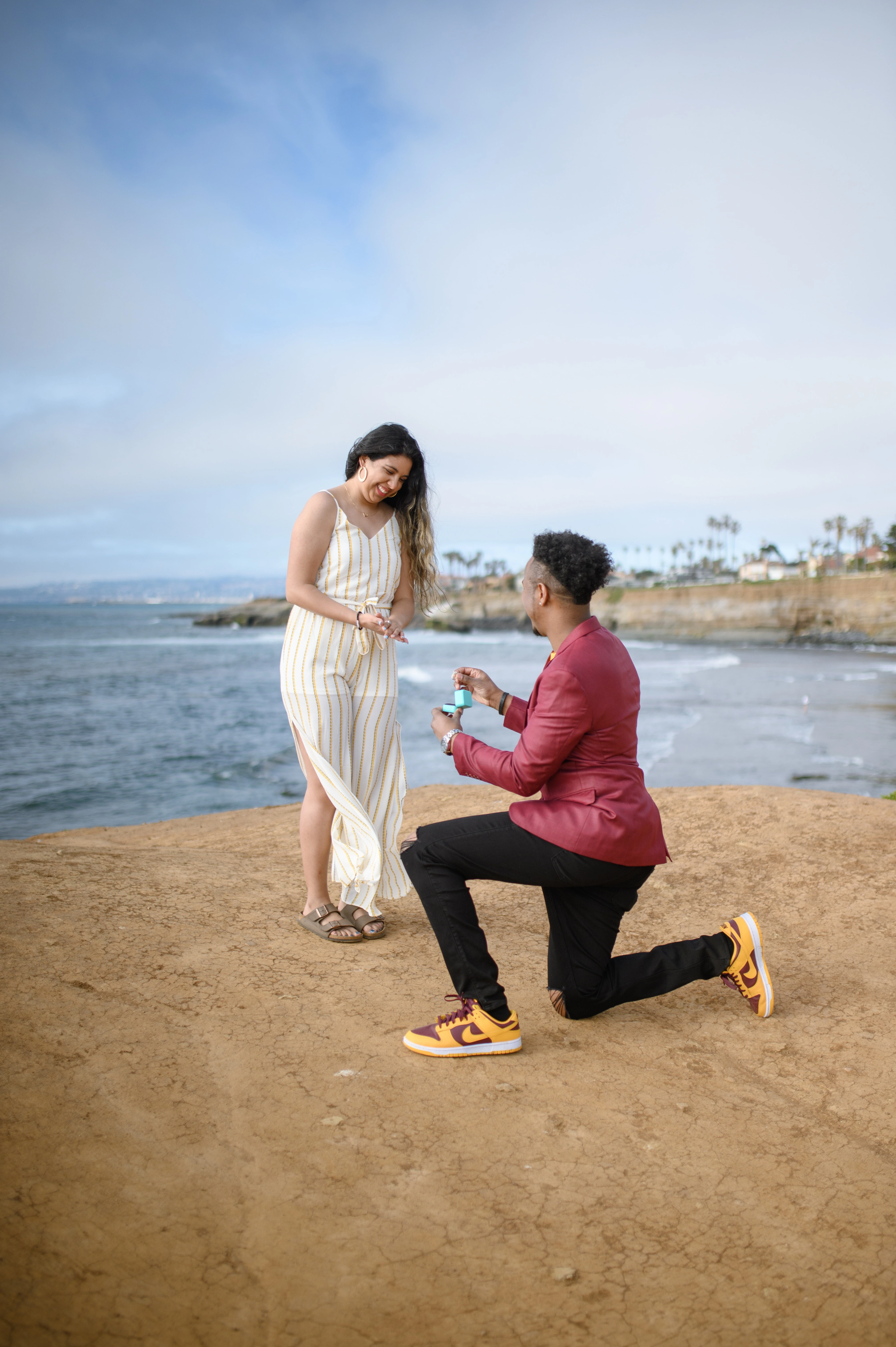 Romantic proposal photographer in San Diego captures a heartfelt engagement moment at Sunset Cliffs, ideal for couples planning a surprise proposal.
