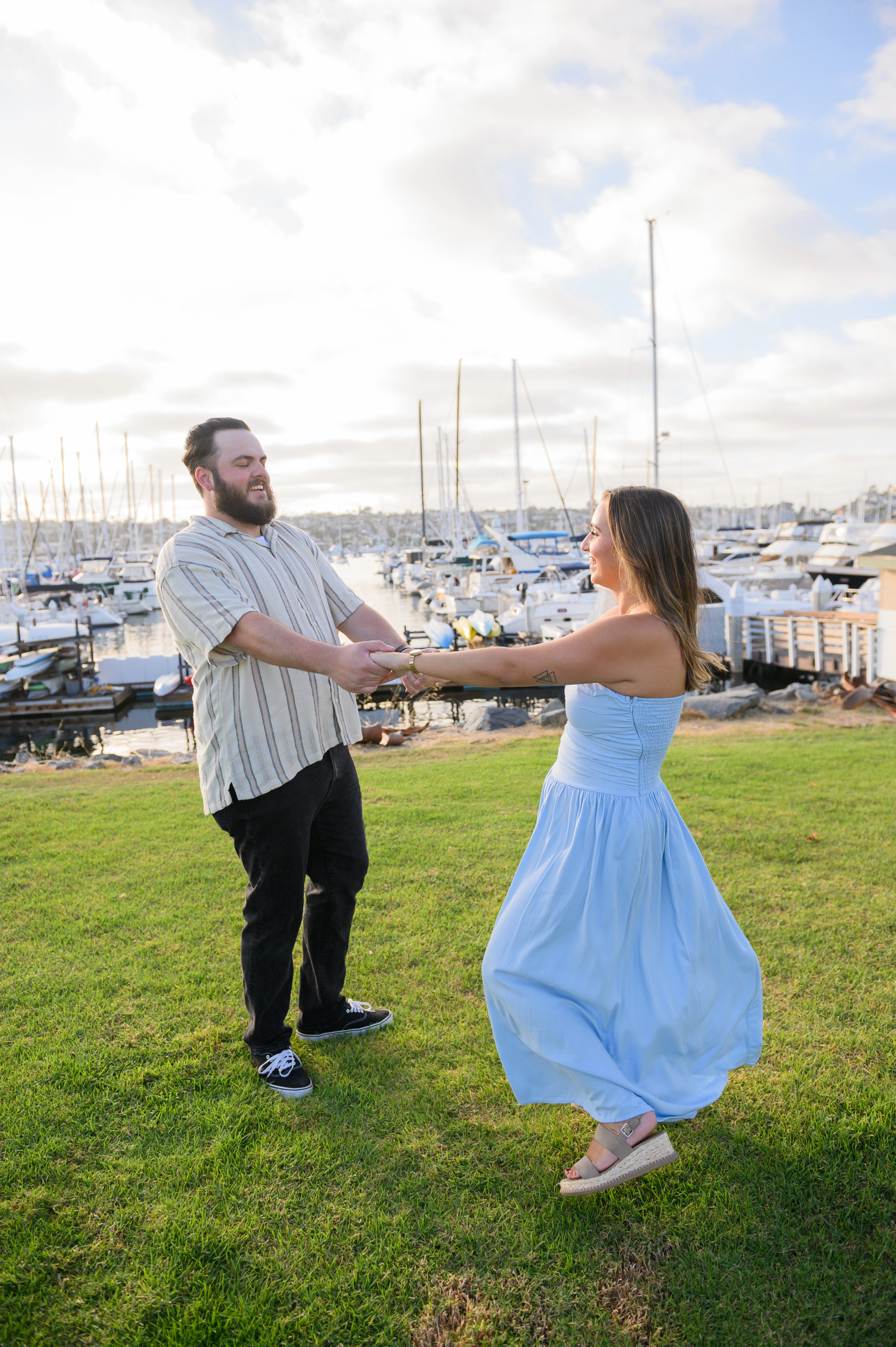 Celebrating their engagement with a joyful dance, this moment highlights the magic of love, captured by a romantic proposal photographer in San Diego.