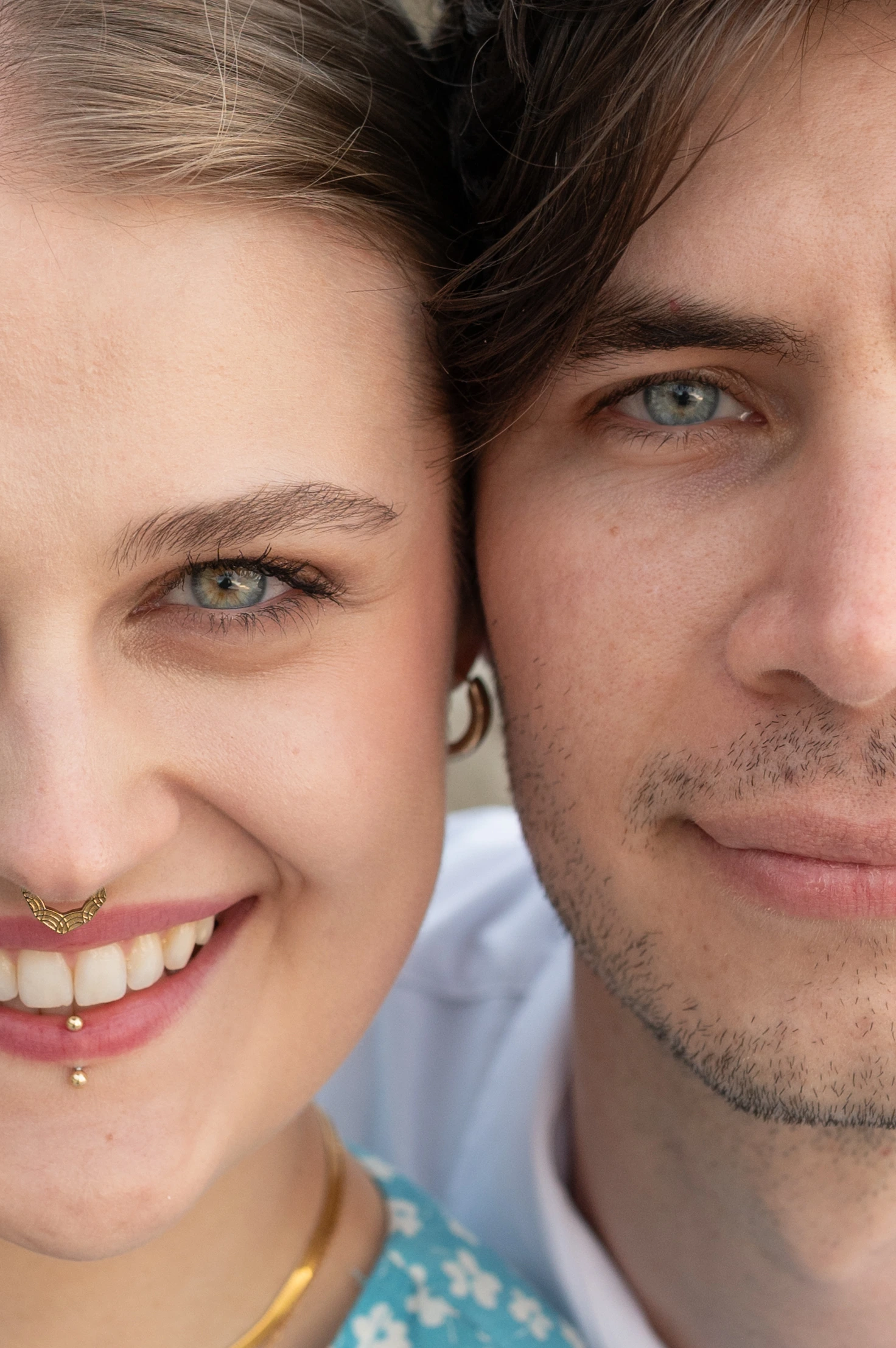 A close-up of the couple's faces, showcasing their smiles and expressions against a blurred background.