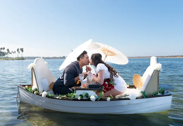 San Diego proposal photographer capturing newly engaged couple in an intimate boat with picnic setup