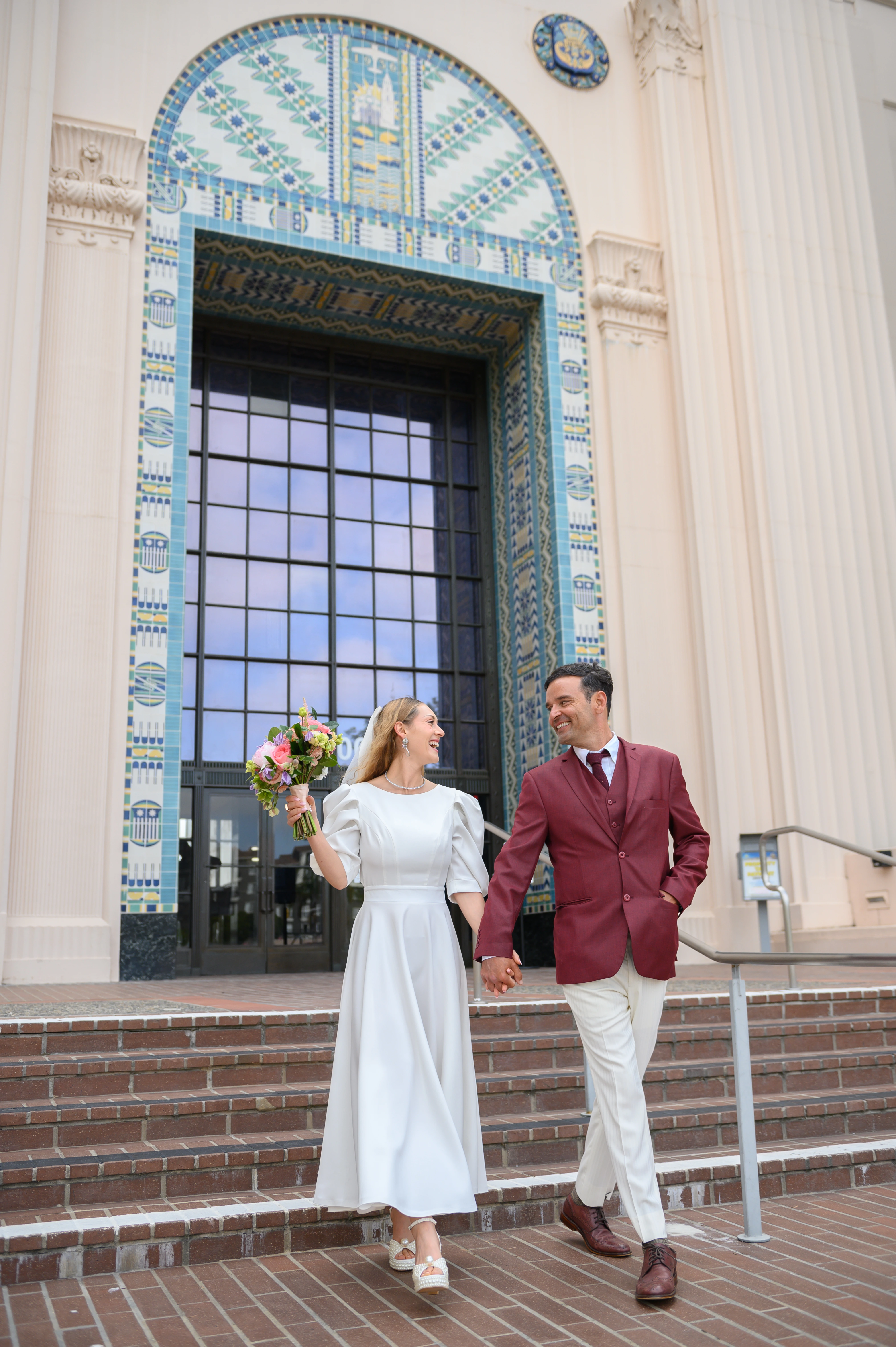 just married couple exiting san diego courthouse hand in hand 