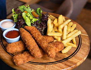 Waiter holding a fried chicken and frenc