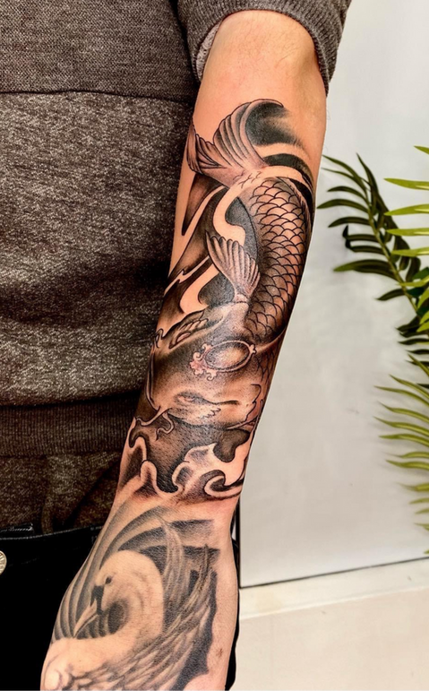 a black and grey Japanese koi fish tattoo by Simon at paradise-tattoo-high-wycombe
