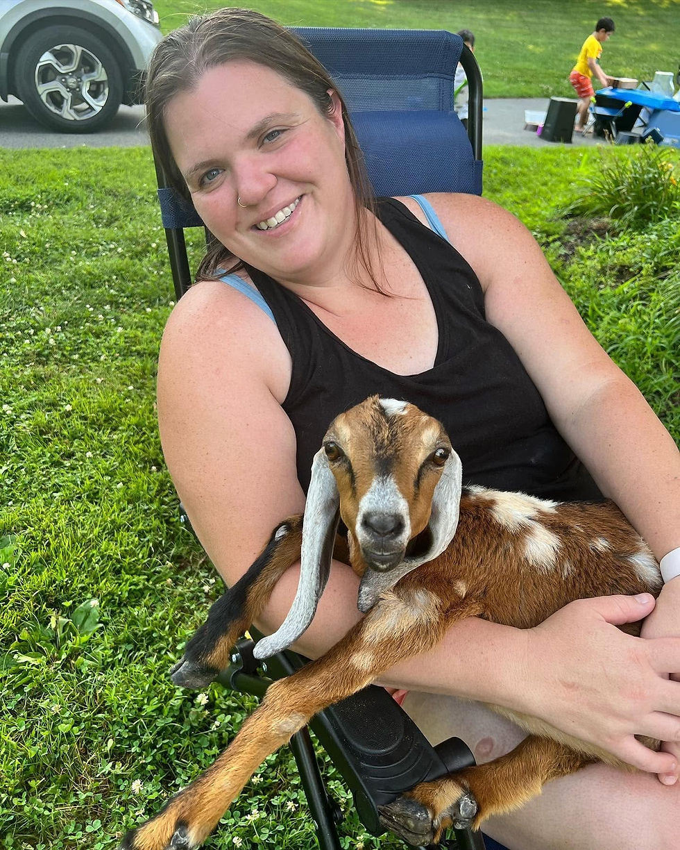 Brooke with a baby Nubian goat in her lap
