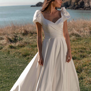 A line, ivory wedding dress. Puff sleeves, key hole back. Madi Lane.