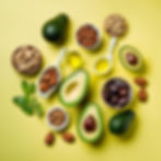 A selection of healthy fats, including avocados, nuts, and olive oil, illustrating their importance in a balanced diet.
