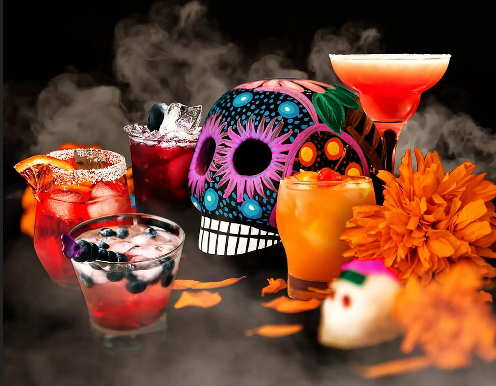 Death's Kiss drink in various glasses with skulls and orange flowers as decoration