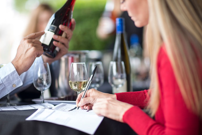 man-and-woman-tasting-wine-and-taking-notes-2023-11-27-05-20-10-utc.jpg