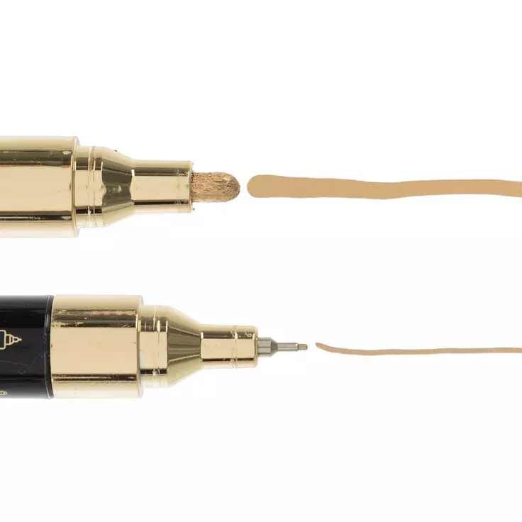 Two gold-tipped markers, one broad and one fine, drawing parallel tan lines on a white background.
