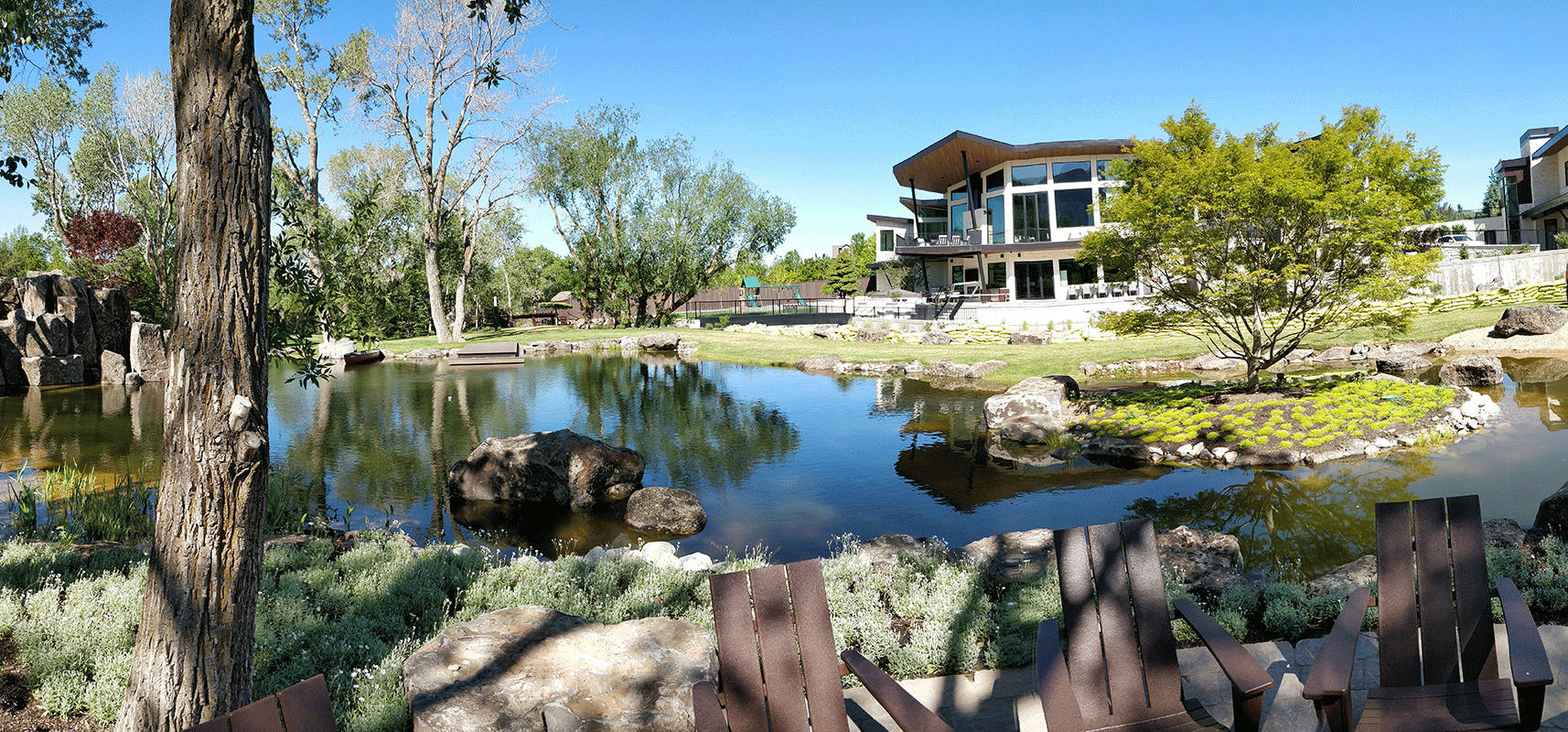 Pond in a beautifully designed landscape of a residential home