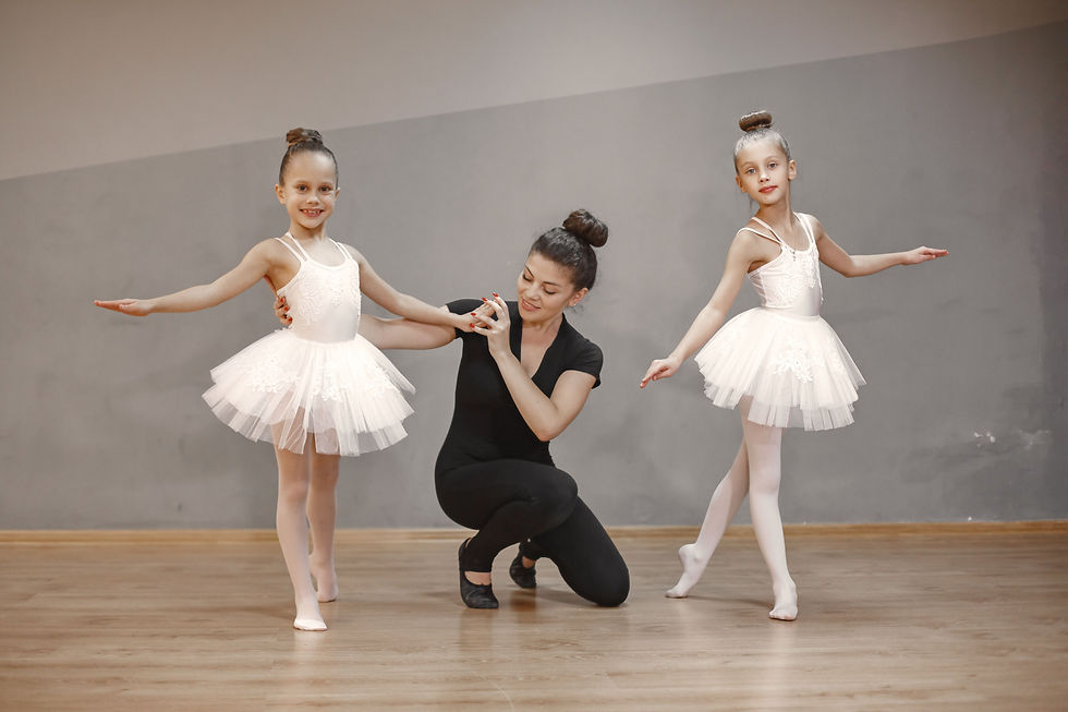 Close-up of a choreographer adjusting a dancer’s arm position during rehearsal