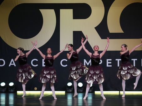 Group of dancers performing on the Oro Dance Competition stage during Season 2, celebrating teamwork, artistry, and passion.