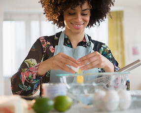 This image reflects a mid-life woman who is preparing a healthy and nutritious meal