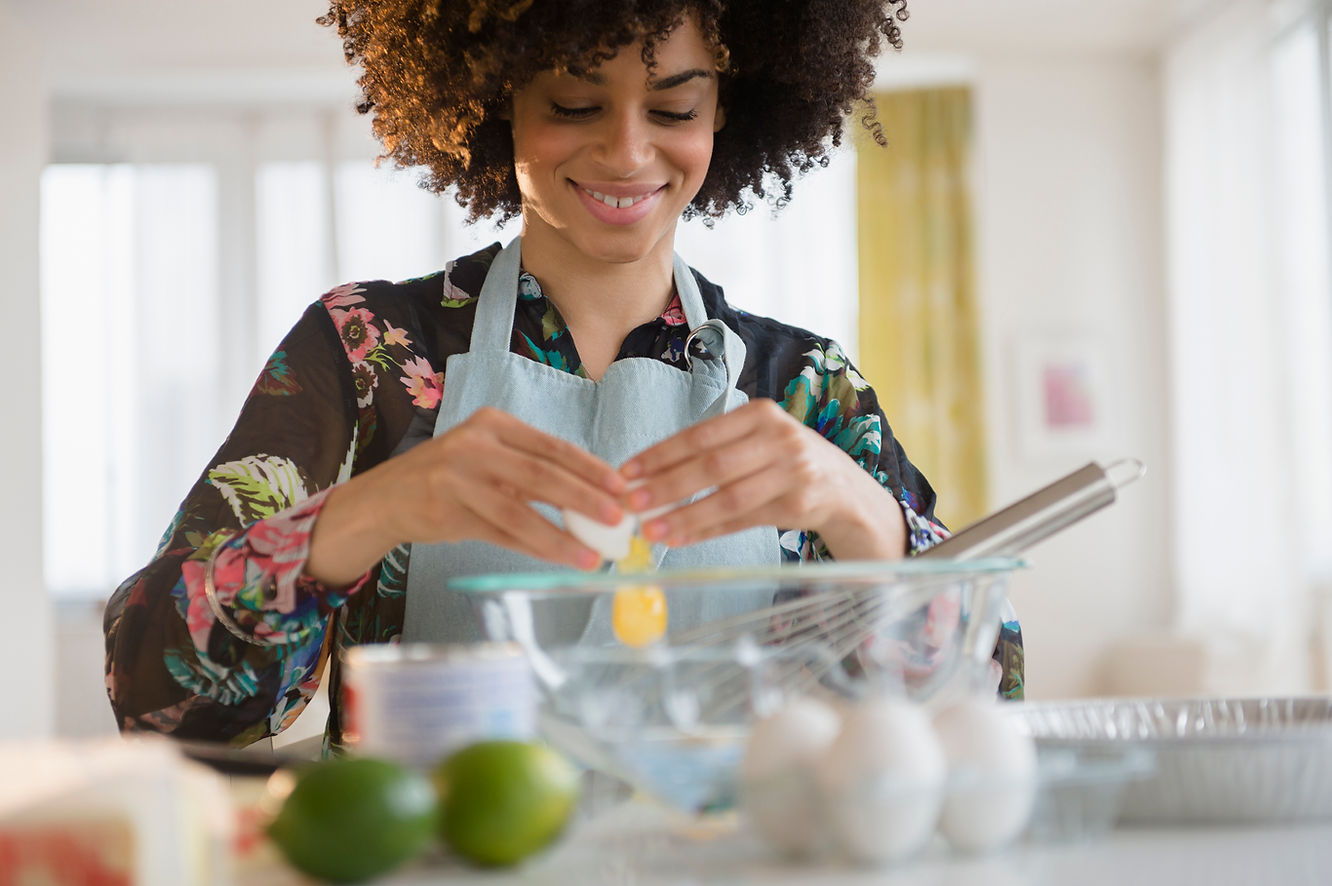 A woman baking with eggs.
